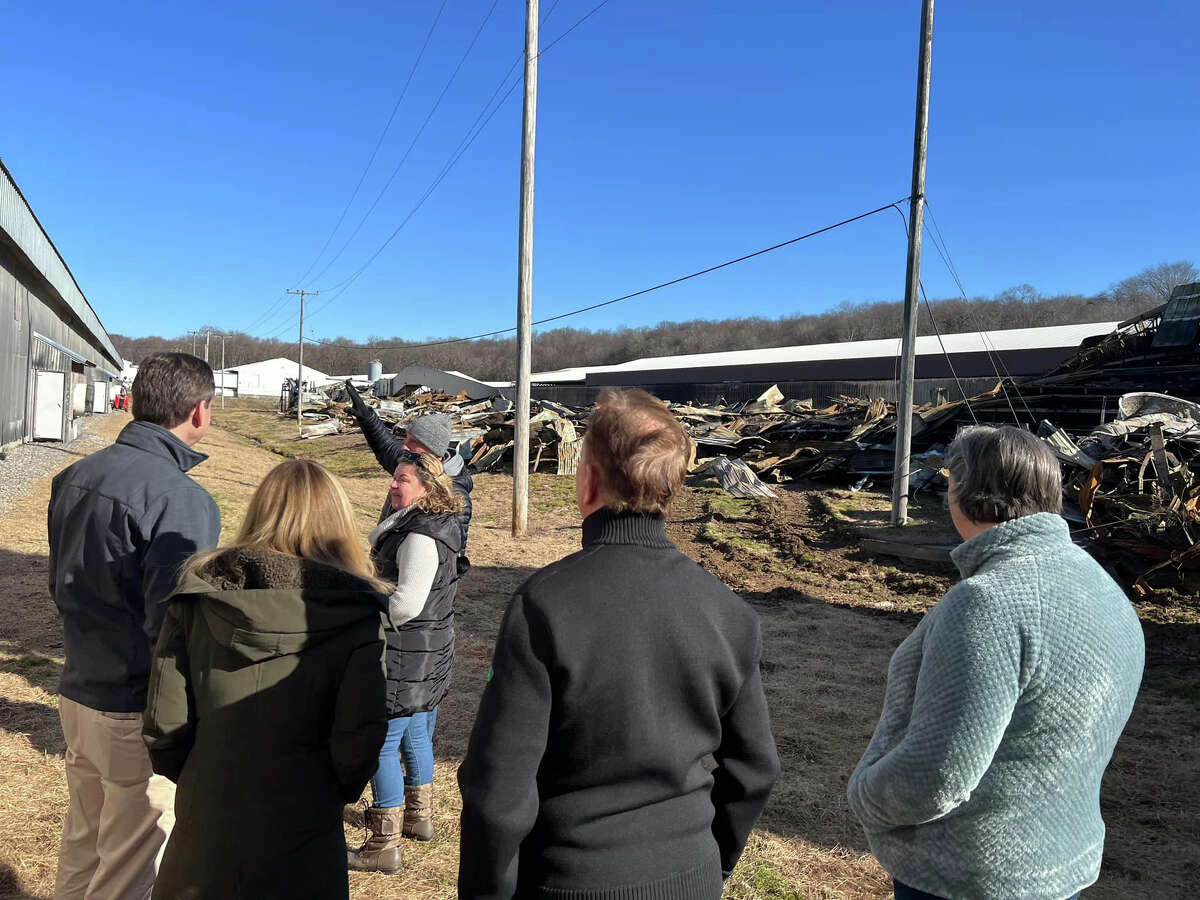 Gov. Ned Lamont, center, surveys a Hillandale Farms hen barn destroyed in a late January 2023 fire in Bozrah, Conn., on Wednesday, Feb. 1, 2023. (Photo via Office of Gov. Ned Lamont)