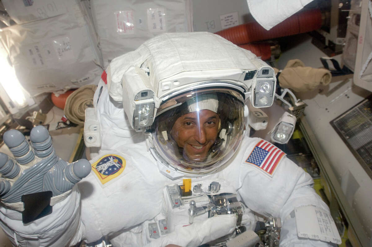 Astronaut Joe Acaba waves as he prepares to leave the Quest Airlock of the International Space Station for a spacewalk on March 21, 2009.