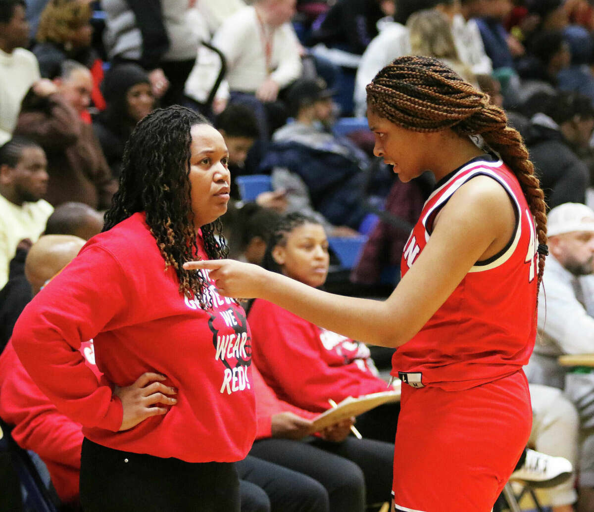 Alton's Jarius Powers (right) and AHS coach Deserea Howard talk at halftime of last week's game at O'Fallon. Alton is ranked No. 4 in this week's AP Class 4A Girls State Basketball Poll.