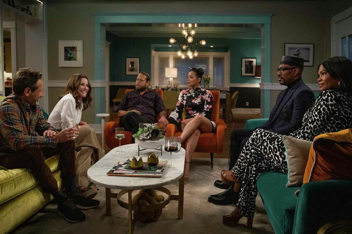 This image released by Netflix shows, from left, David Duchovny, Julia Louis-Dreyfus, Jonah Hill, Lauren London, Eddie Murphy and Nia Long in a scene from "You People." (Parrish Lewis/Netflix via AP)