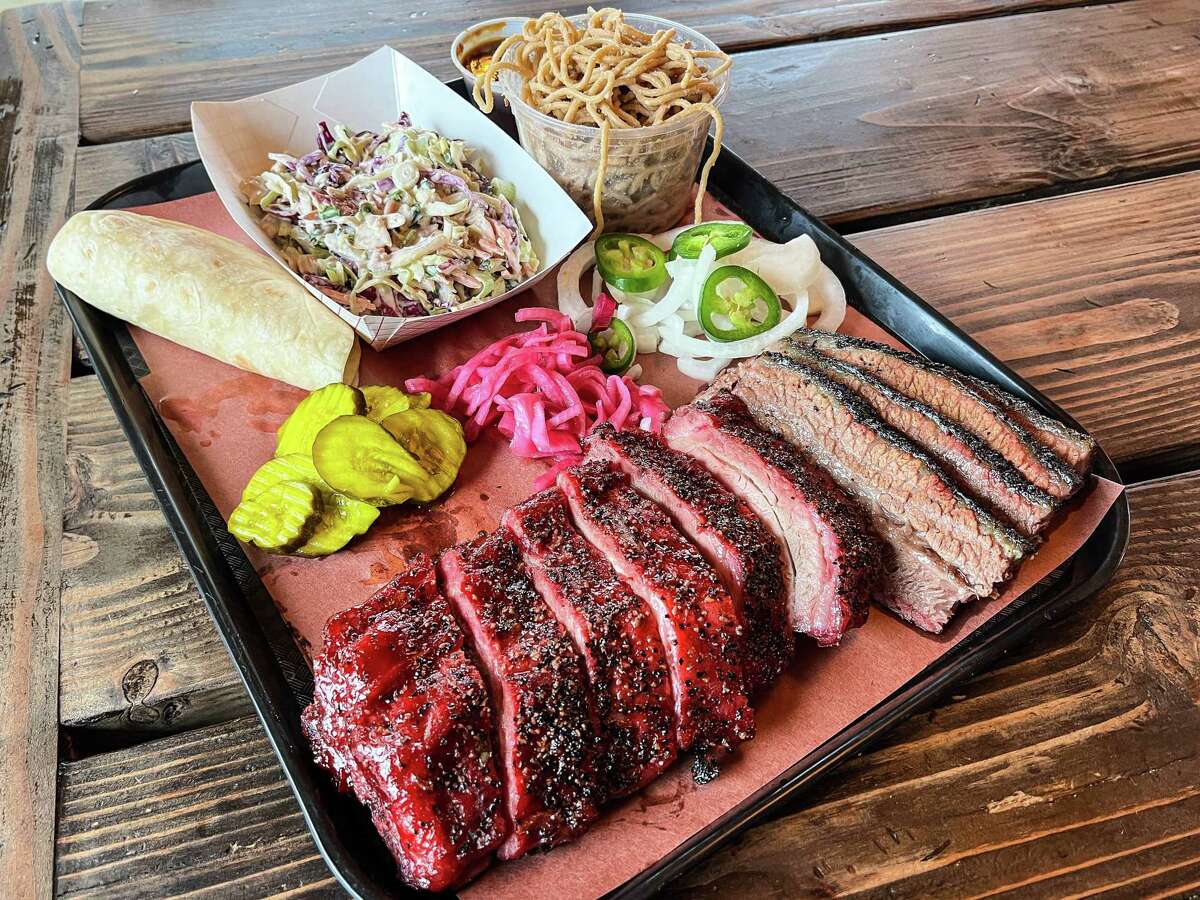 Barbecue tray with coleslaw, cold garlic noodles, brisket and char-siu baby back ribs at Round Top Smokehouse