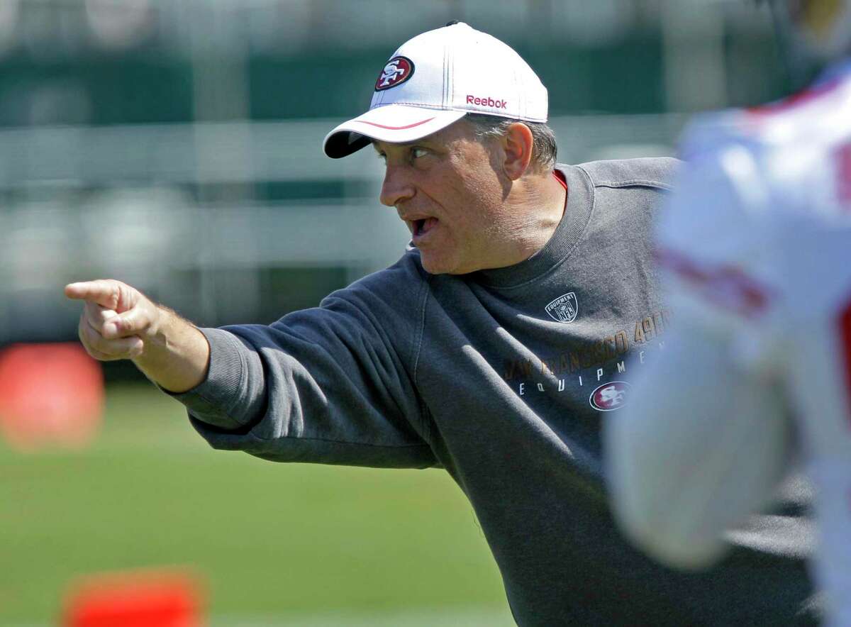 In this July 30, 2011, file photo, San Francisco 49ers defensive coordinator Vic Fangio gestures during NFL football training camp in Santa Clara.