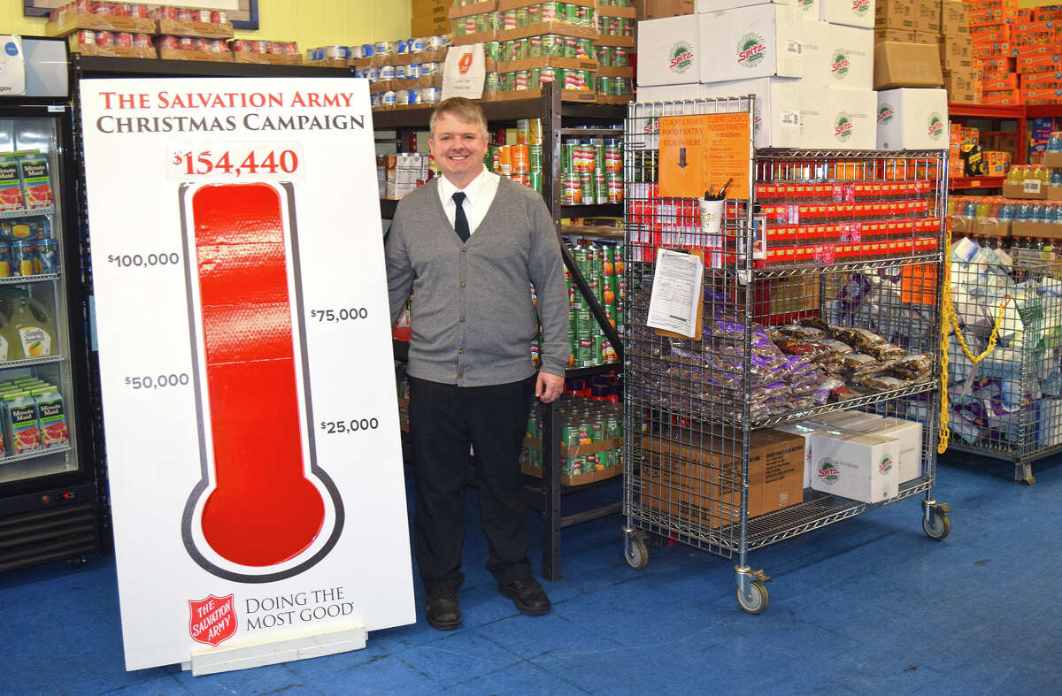 Thanks to an anonymous donor, the Jacksonville chapter of The Salvation Army surpassed its Red Kettle Campaign goal of $150,000 by $4,440. Capt. Chris Clarke stands by the thermometer measuring the good news inside the agency's food pantry.