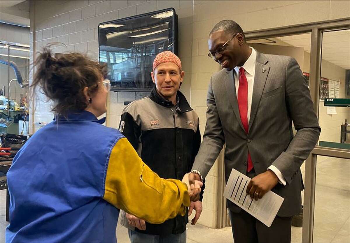 Lt. Gov. Gilchrist meets a Michigan Reconnect student in Delta College's welding lab.