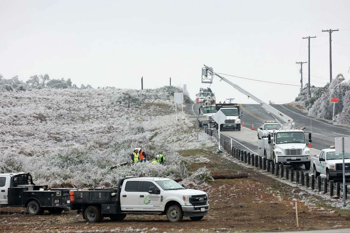 Crews work on down power lines and poles at the corner of Texas 46 and FM 3159 east of Bulverde, Texas, Thursday, Feb. 2, 2023. The area was hit hard by the ice storm this week. A section of Texas 46, between FM 3159 and FM 311 was closed to traffic due to down power lines.
