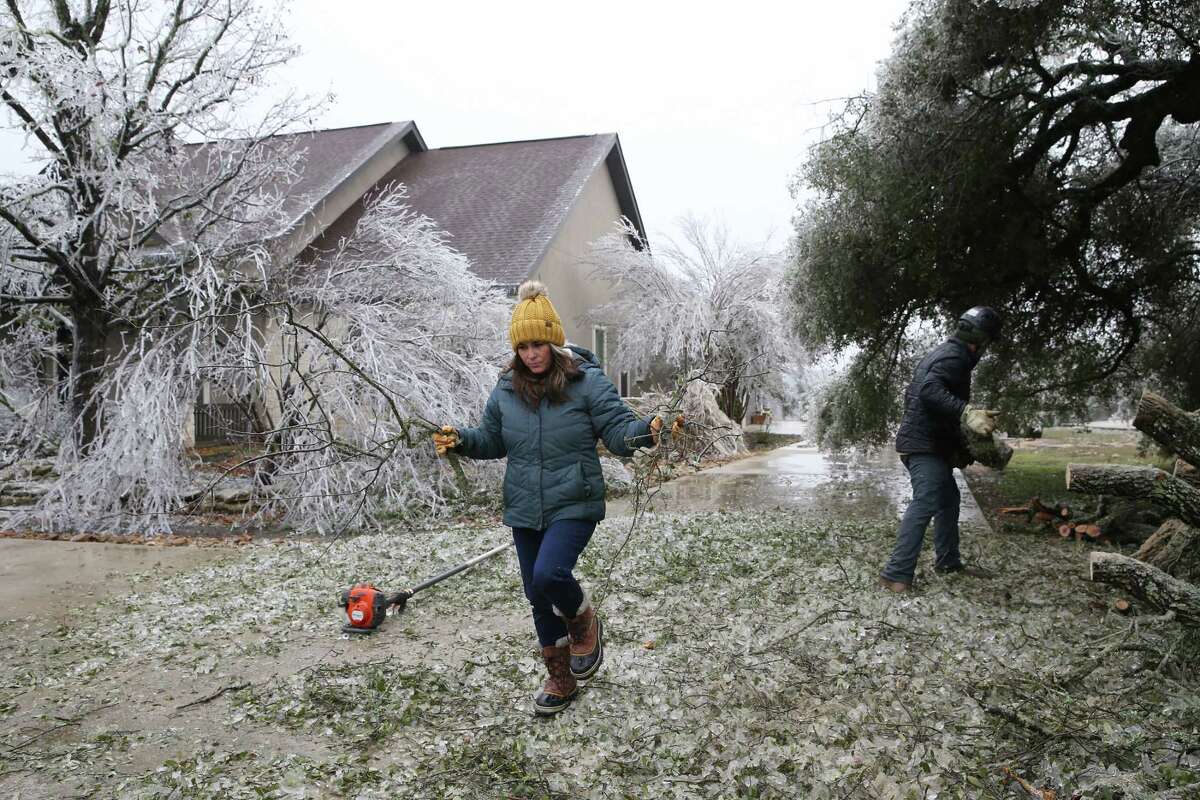 Katy Allbritton and her fiancé, Kevin Henderson, cleans up the Mead residence on Rebecca Creek Road in Bulverde, Texas, Thursday, Feb. 2, 2023.