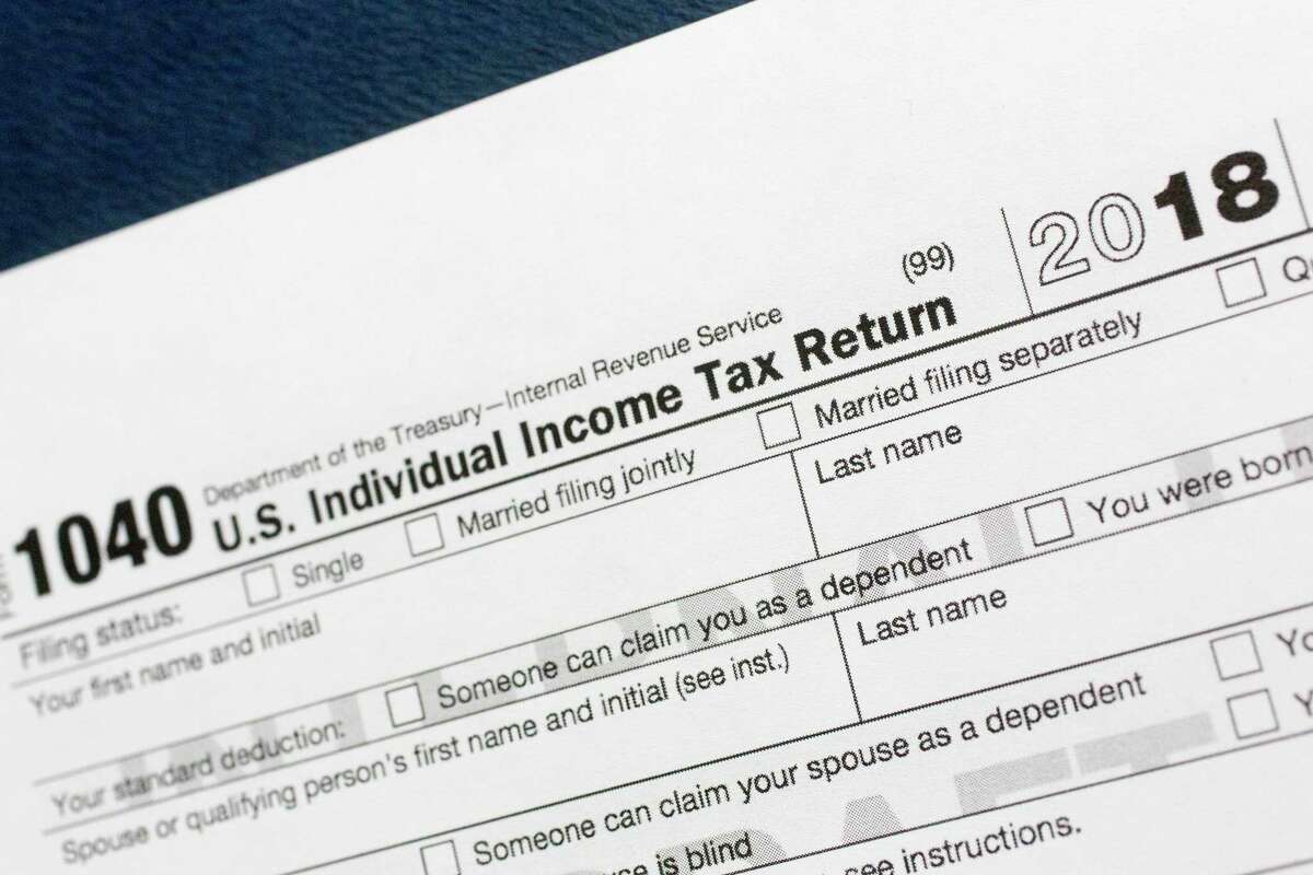 This July 24, 2018, file photo shows a portion of the 1040 U.S. Individual Income Tax Return form for 2018 in New York. (AP Photo/Mark Lennihan, File)