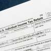 FILE - This July 24, 2018, file photo shows a portion of the 1040 U.S. Individual Income Tax Return form for 2018 in New York. If you’ve lost or never received your W-2, old tax returns, 1099s or 1098s to complete your tax return, there are a few things you can do to get back on track and give yourself more time. (AP Photo/Mark Lennihan, File)