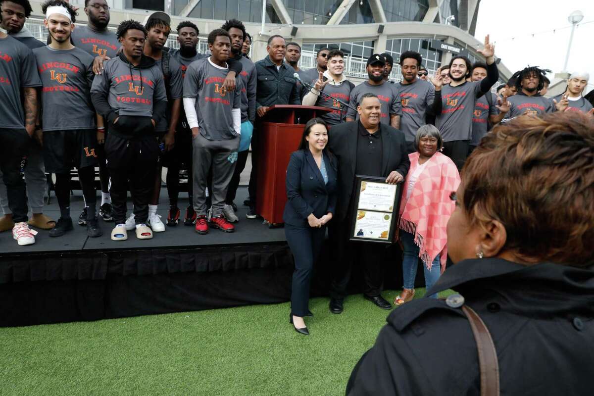 Oakland Mayor Sheng Thao (front left), African American Sports and Entertainment Group founder Ray Bobbitt and Egypt King of Bigg Mama’s Best Foundation celebrate the future of the Oakland Coliseum site with Lincoln University Football team members.