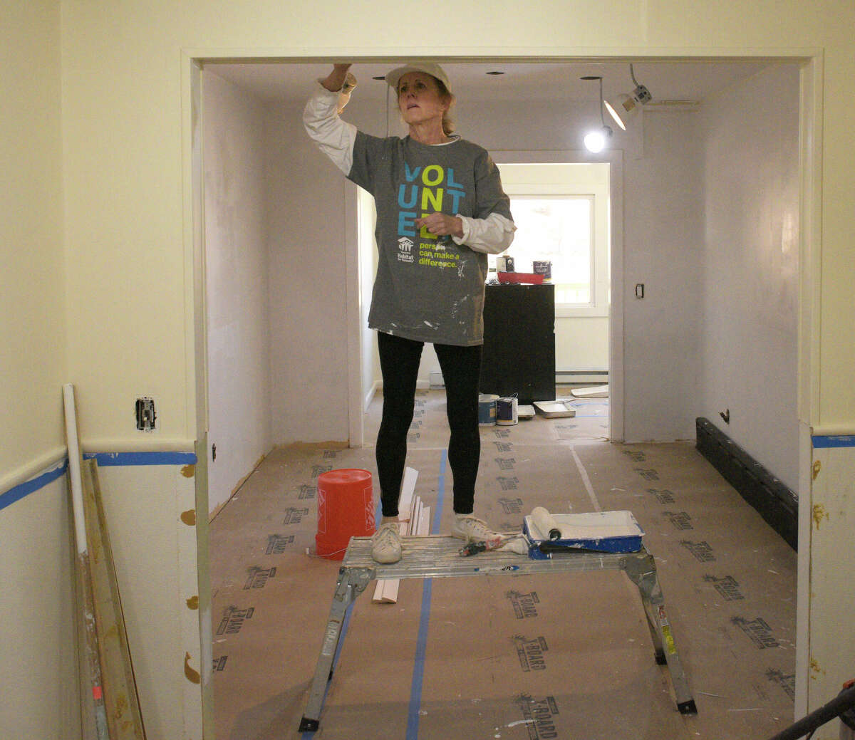 Volunteer Nancy Toussaint, of Danbury, works with other volunteers on an Ability Beyond group home that is the first-ever collaboration between non-profits Housatonic Habitat for Humanity and Ability Beyond. They are renovating/upgrading an Ability Beyond group home in Danbury, Conn. Thursday, February 2, 2023.