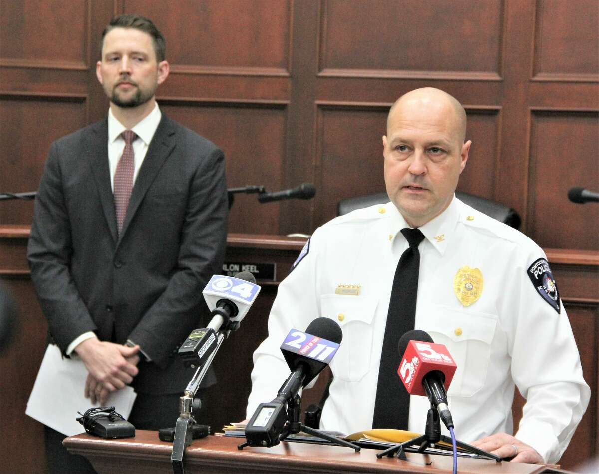Pontoon Beach Police Chief Chris Modrusic talks while Madison County State's Attorney Tom Haine looks on during a press conference detailing charges against Roger Dale Sutton Jr., 55, who was charged with murder, and his nephew, Nathan J. Beyer, 32, of Alton, who was charged with concealing a homicide in the death of Patrenia Butler-Turner, 40, who was reported missing 10 years ago. The cold case opened up after her remains were found Dec. 5 in woods near Illinois 111 in Pontoon Beach. The two suspects were indicted by a Madison County grand jury Thursday.