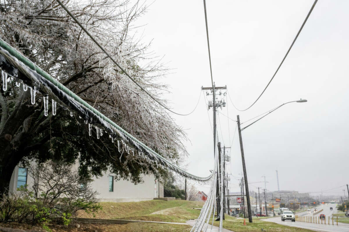 Frozen power lines are seen hanging near a sidewalk on February 01, 2023 in Austin, Texas. A winter storm is sweeping across portions of Texas, causing massive power outages and disruptions of highways and roads. 