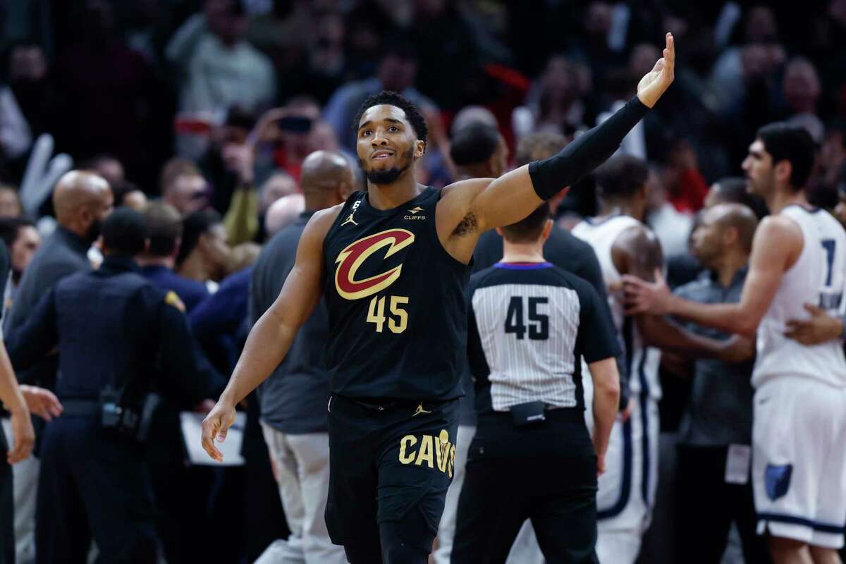 Cleveland Cavaliers guard Donovan Mitchell waves to the crowd after fighting with Memphis Grizzlies forward Dillon Brooks during the second half of an NBA basketball game, Thursday, Feb. 2, 2023, in Cleveland. Mitchell and Brooks were ejected from the game.