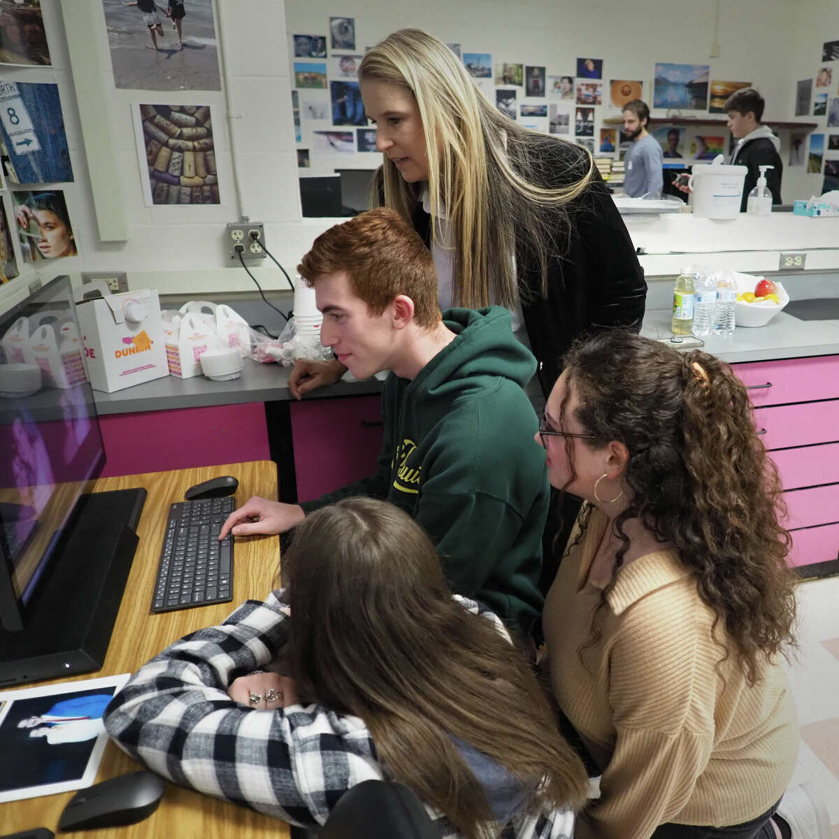 Florida photographer Krista Kowalczyk, rear, who started the restoration project, working with Amity High School students on a recent schoolday.