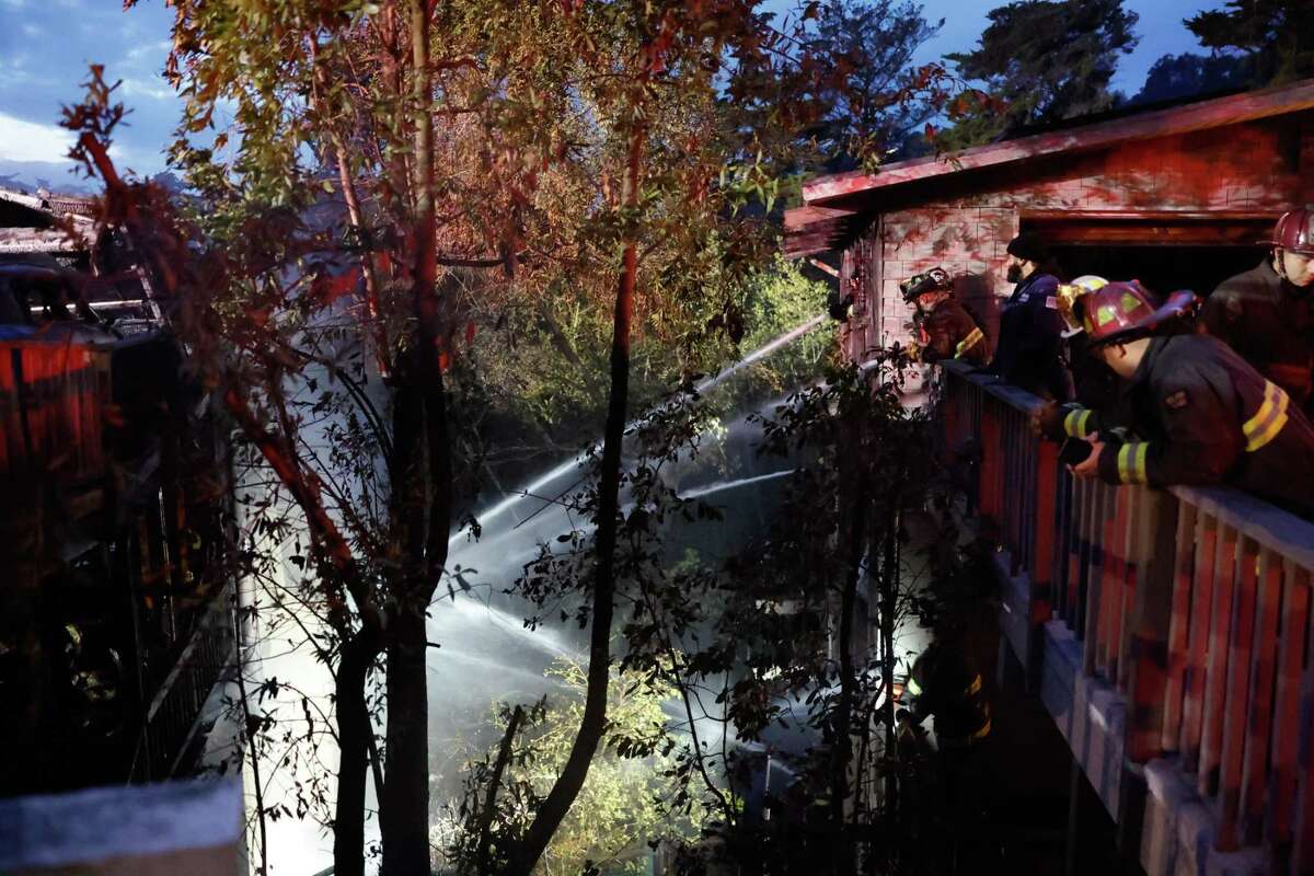 Oakland firefighters put out a blaze involving three houses in one of the city’s “high severity zones.”