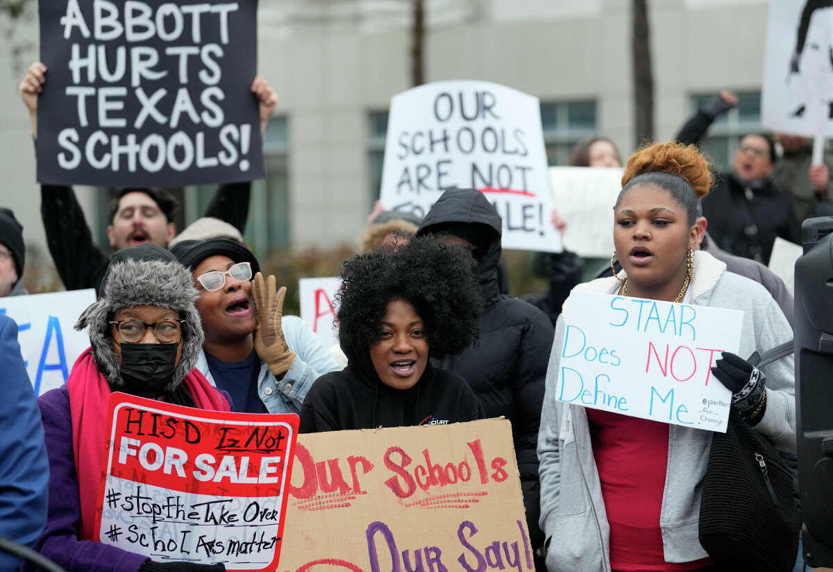 People participate in a rally opposing the state takeover of the Houston Independent School District outside the Hattie Mae White Educational Support Center, 4400 W 18th St., Thursday, Feb. 2, 2023, in Houston.