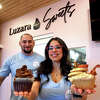 Sarah Luz Laffitte-DePalmer and her husband, James DePalmer, pose with a couple of the cupcake samples that will be available at Luzara Sweets, opening soon in Shelton, Conn., Feb. 3, 2023.