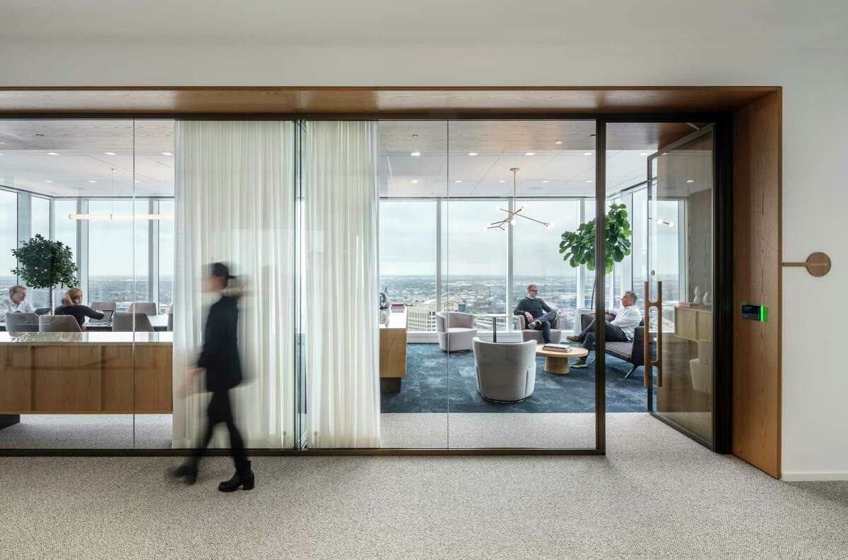 Conference rooms feature glass walls so people can see in and out, and they combine more formal table seating as well as sofas and chairs.