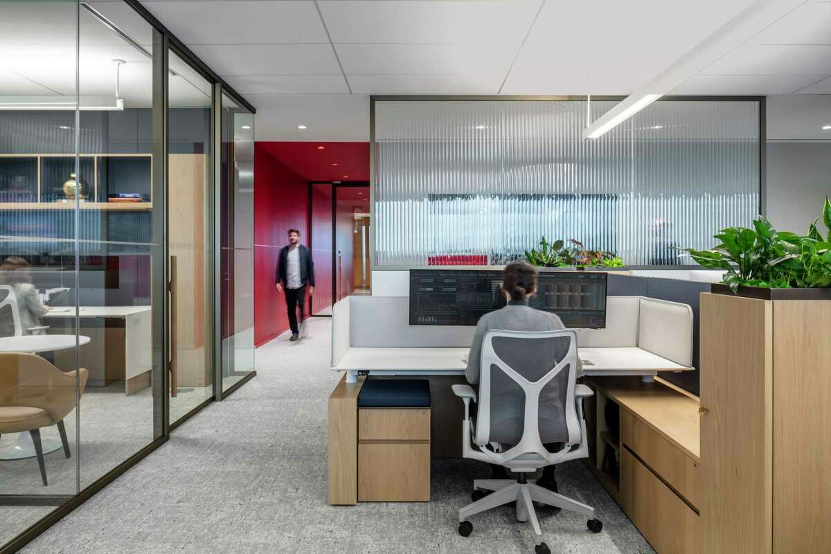 Work spaces are a combination of smaller offices and work cubicles, and all have sit-or-stand desks that adjust to any height.
