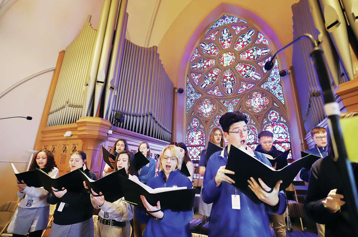 John Badman|The Telegraph Members of the Marquette Catholic High School chorus sing from the balcony of St. Mary's Catholic Church in Alton Thursday afternoon during a Mass celebrated by Bishop Thomas John Paprocki.