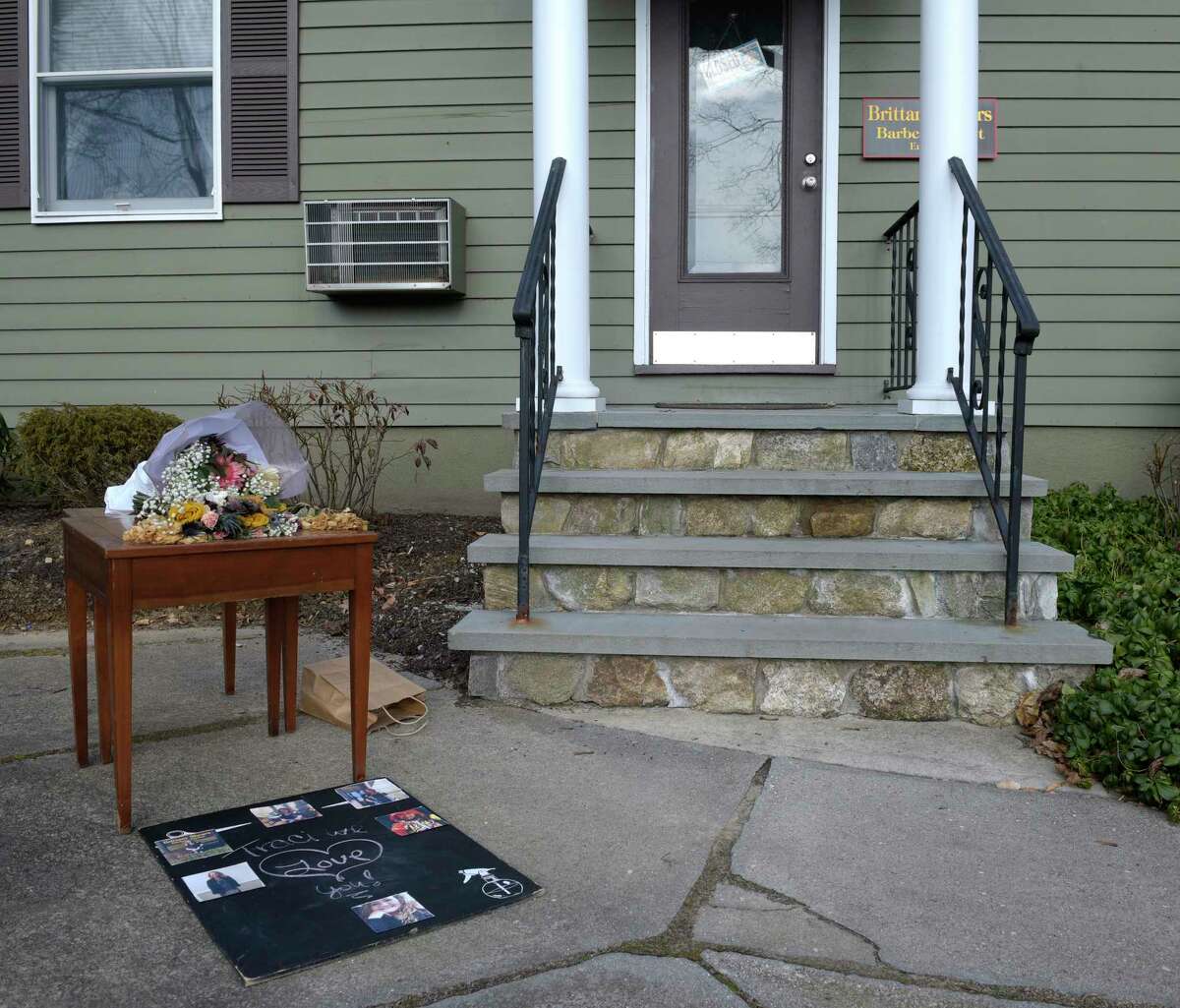 A table has been set up in front of the Brittany Shears hair salon where people have left flowers and mementos honoring Traci-Marie Jones. Jones, a 52-year-old mother of three who worked at the salon, was killed at her Reservoir Street home on Tuesday. Bethel, Conn, Friday, February, 3, 2023.