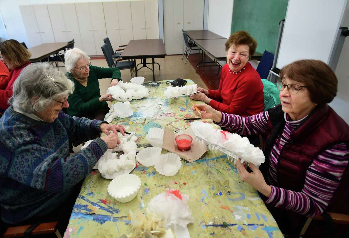 From left; Seniors Eunice White, Carolyn Durgy, Carol Karpovich, and Olga Voras, create a Valentine's Day craft in an art class at the Bigelow Center for Senior Activities in Fairfield, Conn. on Friday, February 3, 2023.