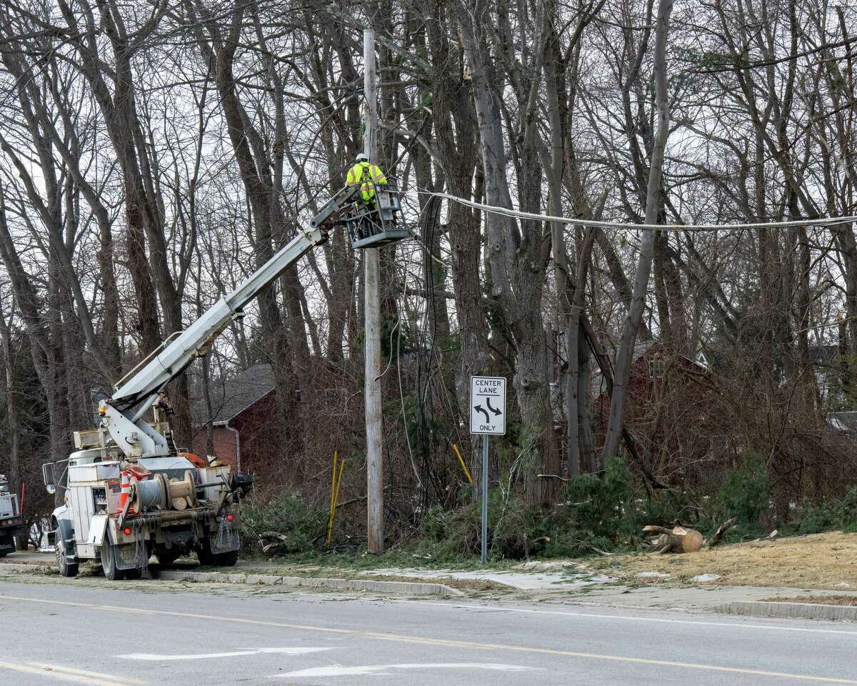 A crew working with National Grid repair wires that were knocked down by a tree on Friday, Feb. 3, 2023, on Fuller Road in Albany, NY.