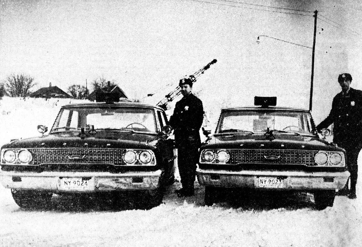 Standing beside two new Manistee City Police patrol cars are (from left) officers Walt Witkowski and Ed Boyle. The cars are the first used under a system of leasing rather than purchasing patrol cars. They are black Fords leased from Mackin Motors. The photo was purchased in the News Advocate on Feb. 6, 1963.