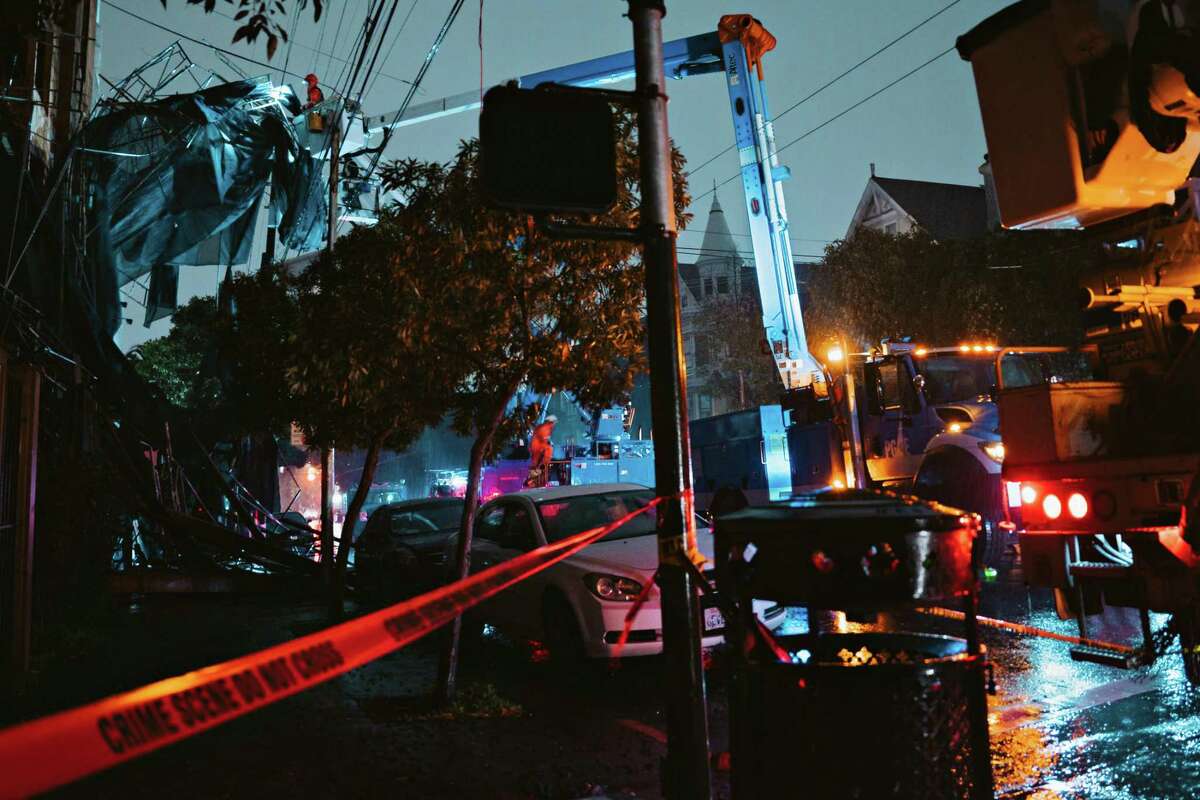 PG&E employees work to fix a power outage on the 900 block of South Van Ness Ave in San Francisco on Jan. 4. Outages caused by severe weather remain a challenge, even as the state encourages people to switch to electric cars and appliances.