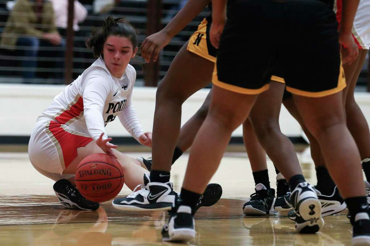 Porter's Macie Garcia (24) tires to control a loose ball in the first quarter of a District 16-5A high school basketball game at Porter High School, Friday, Feb. 3, 2023, in Porter.
