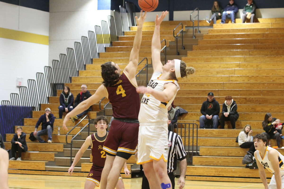The opening tip-off between Bad Axe's Jake MacPhee and Reese's Beck Shores.
