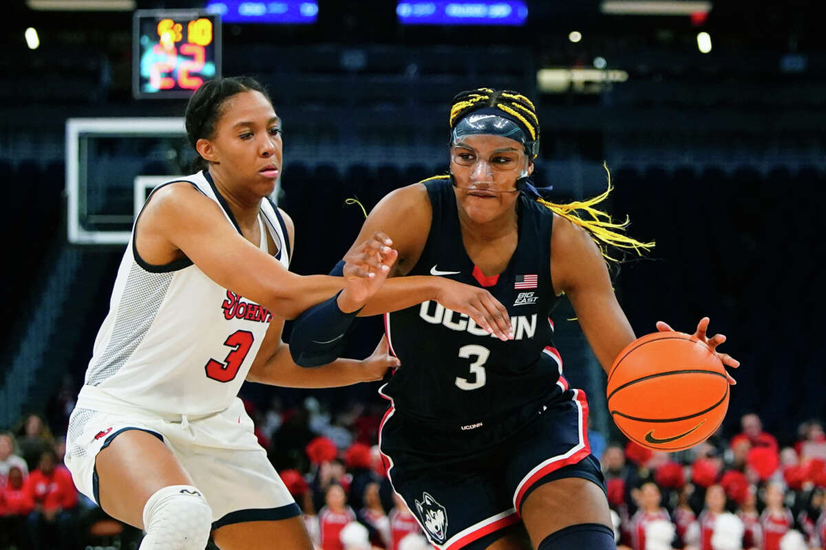 Connecticut's Aaliyah Edwards (3) drives past St. John's Danielle Patterson (3) during the second half of an NCAA basetball game Wednesday, Jan. 11, 2023, in New York. Connecticut won 82-52. (AP Photo/Frank Franklin II)