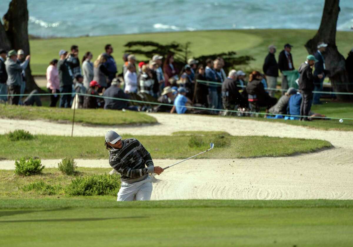 Larry Fitzgerald hits from the bunker at the 6th hole on the Monterey Peninsula Country Club golf course during the AT&T Pebble Beach Pro-Am on Thursday, Feb. 3, 2022 in Pebble Beach, Calif.