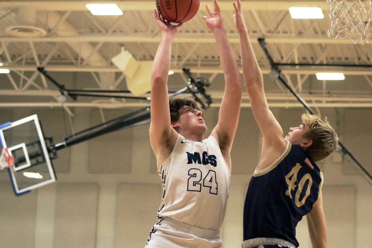 Logan Schwenk rises for a layup against Father McGivney during the Lions' 48-36 win on Friday. 