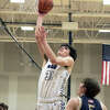Dawson Hendrick scores in the post against Father McGivney on Friday. Hendrick scored 14 points in the Lions' 48-36 win. 