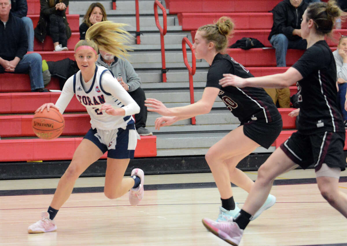 Faith Doyle of Foran dribbles past two North Haven defenders during first half action Friday night.