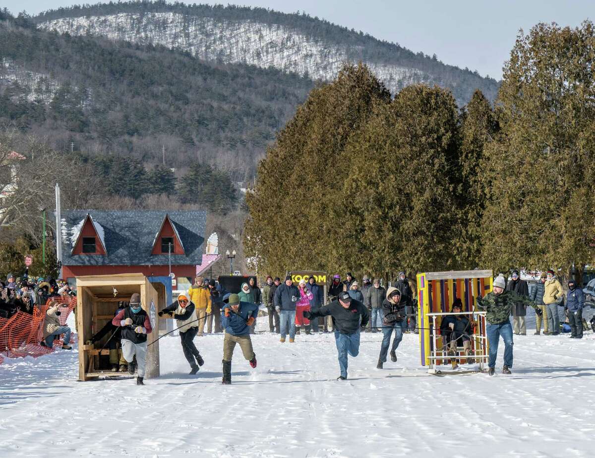Hike with Jackson, left, and Adirondack Studios race their outhouses during the Lake George Winter Carnival on Saturday, Feb. 4, 2023, in Lake George, NY.