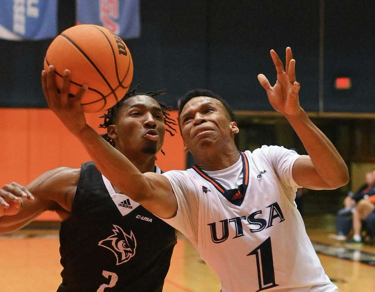 Japhet Medor scores two of his thirty points for UTSA as Mekhi Mason of Rice chases during college basketball action at the Convocation Center on Monday, Jan. 16, 2023. Rice won, 88-81.