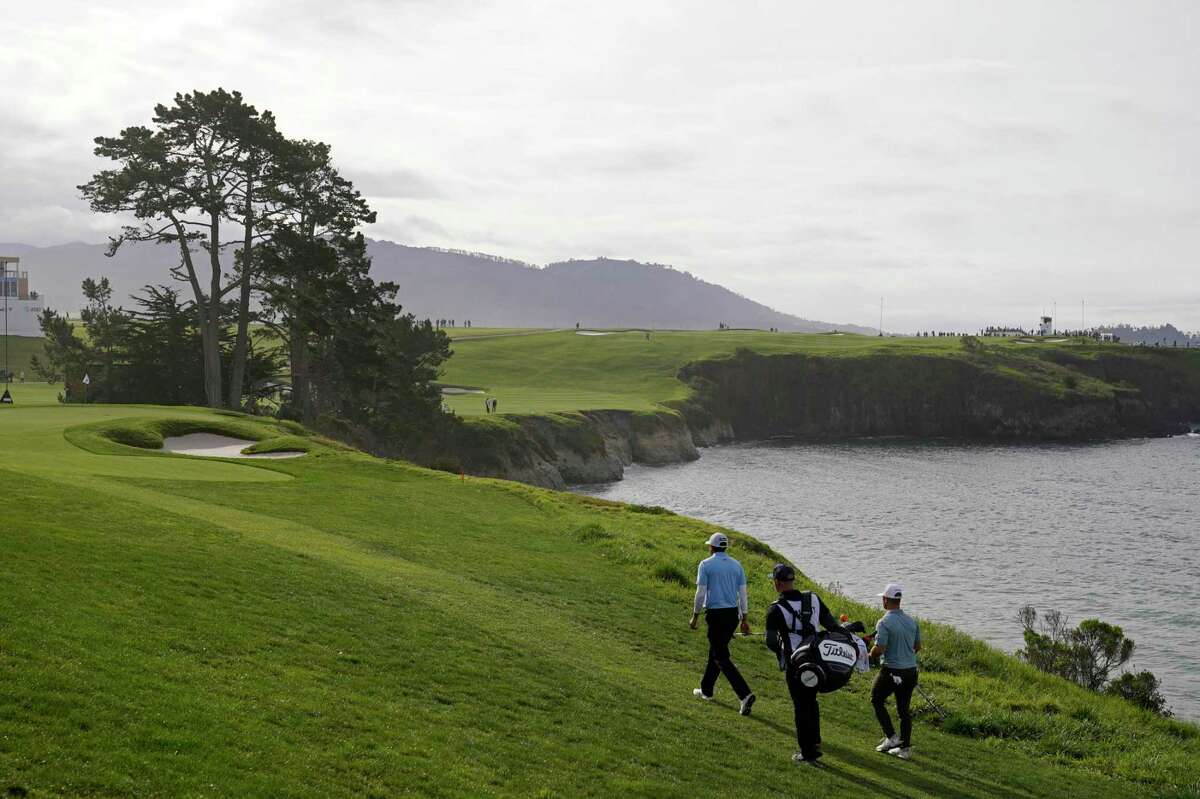 Joseph Bramlett, left, and David Lingmerth, right, walk to the fifth green of the Pebble Beach Golf Links during the third round of the AT&T Pebble Beach Pro-Am golf tournament in Pebble Beach, Calif., Saturday, Feb. 4, 2023. (AP Photo/Eric Risberg)