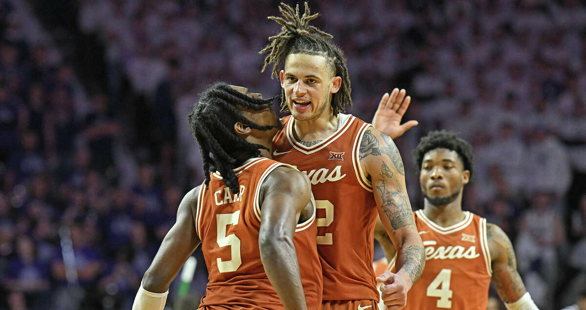 Christian Bishop #32 and Marcus Carr #5 of the Texas Longhorns celebrate after beating the Kansas State Wildcats 69-66 at Bramlage Coliseum on February 4, 2023 in Manhattan, Kansas. (Photo by Peter Aiken/Getty Images)