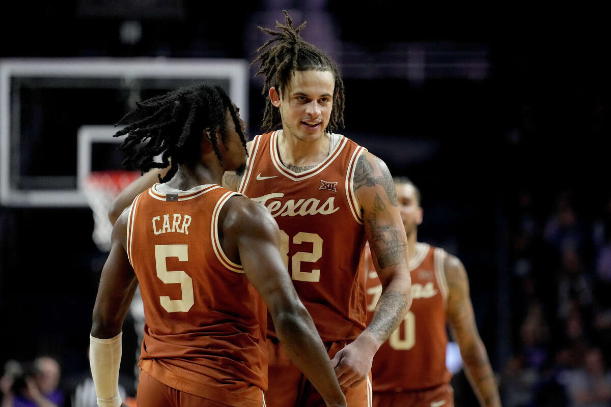 After helping Texas knock off Kansas State on Saturday, guard Marcus Carr (5) and forward Christian Bishop (32) will try to keep the Longhorns on top of the Big 12 when they visit Kansas on Monday night. 