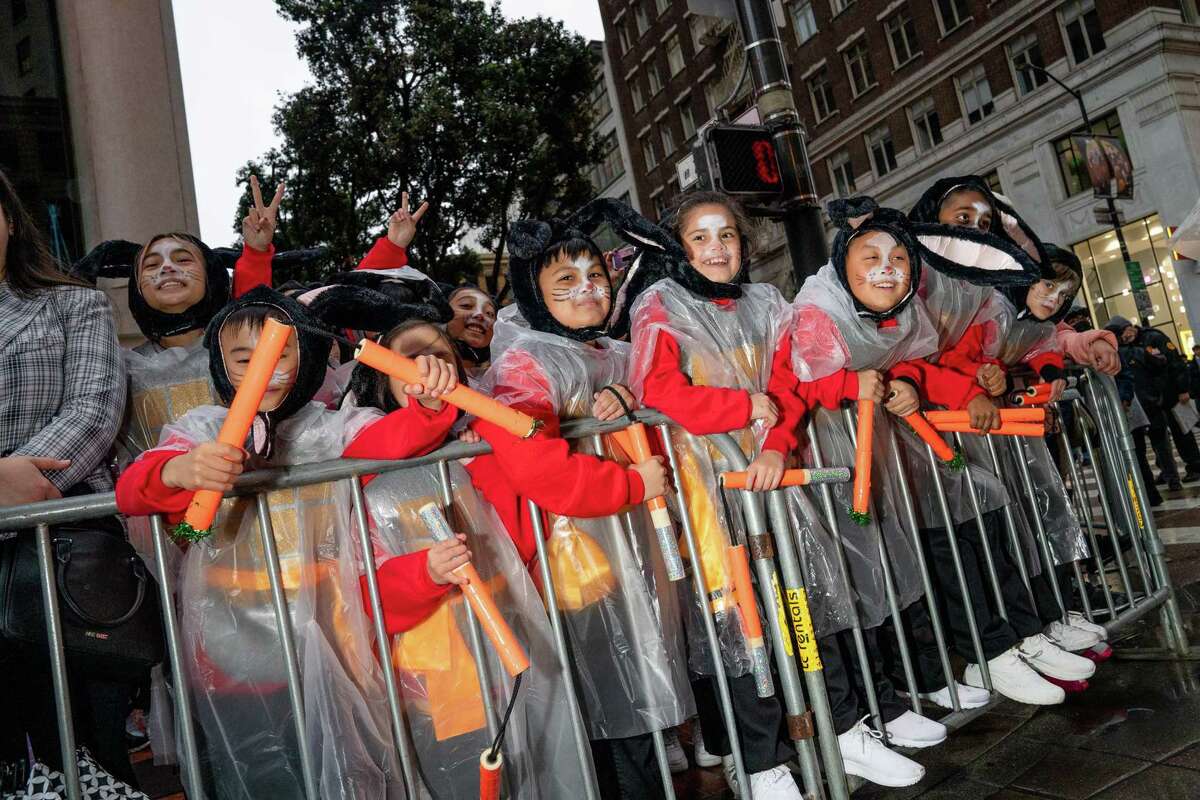 Children wearing rabbit hats wait for the Chinese New Year Parade, which celebrates the Year of the Rabbit.
