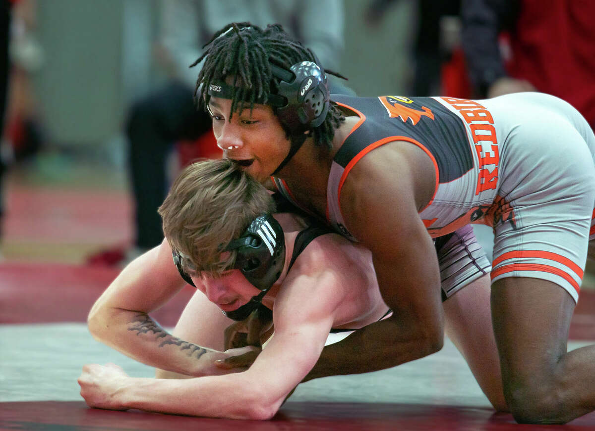 William Harris of Alton, top, grapples with Belleville West's Tyson Seibel Saturday in a 126-pound bout at the 3A regional at Alton High. Harris won the bout 10-3 and went on to finish second in the weight class.