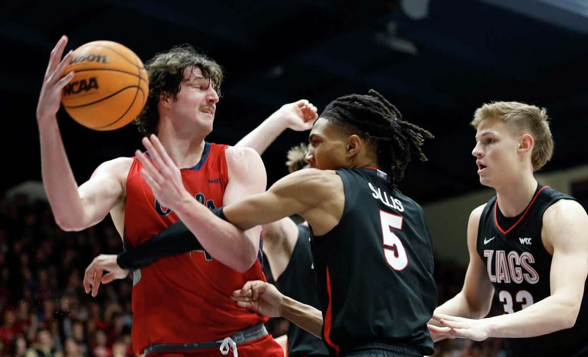 St. Mary's Gaels guard Alex Ducas (44) wrestles an offensive rebound from Gonzaga Bulldogs guard Hunter Sallis (5) in the 1st halt at the University Credit Union Pavilion on Saturday, Feb. 4, 2023 in Moraga, Calif.