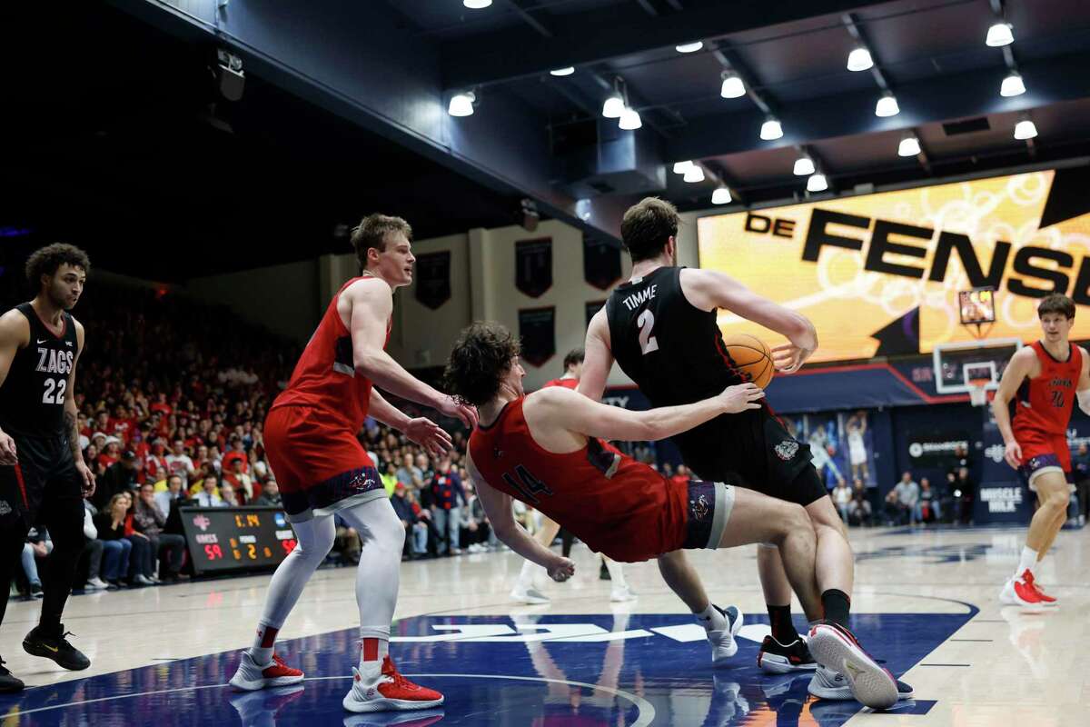 St. Mary's Gaels forward Kyle Bowen (14) draws an offensive foul in overtime against Gonzaga Bulldogs forward Drew Timme (2) in the Gael 78-70 win over Gonzaga in overtime at the University Credit Union Pavilion on Saturday, Feb. 4, 2023 in Moraga, Calif.