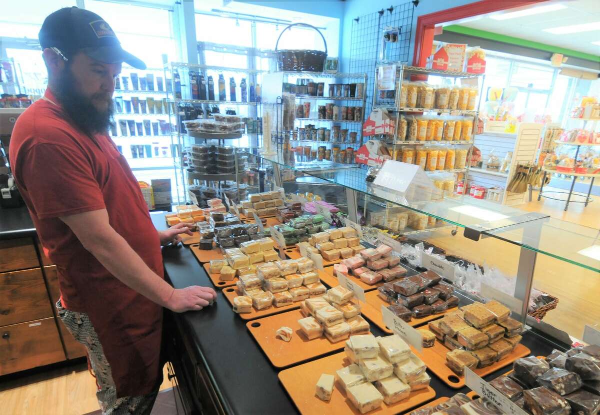 P.J. Schneider makes sure the fudge case is full at the Chef's Shoppe in Edwardsville on Saturday. Valentine's Day is a busy time at the store.