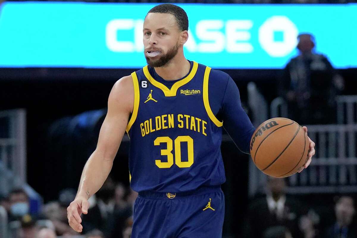 Golden State Warriors guard Stephen Curry (30) brings the ball up the court against the Dallas Mavericks during the second half of an NBA basketball game in San Francisco, Saturday, Feb. 4, 2023. (AP Photo/Jeff Chiu)