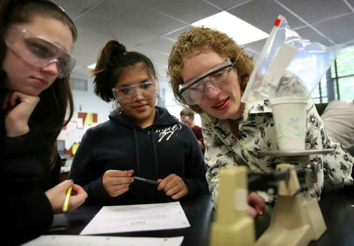 Connecticut's Teacher of the Year Kristen Record, right, works on an experiment with freshmen Tess Harkins, left, and Renata Aguirre in her Studies in Science class at Bunnell High School in Stratford on Tuesday, October 12, 2010.
