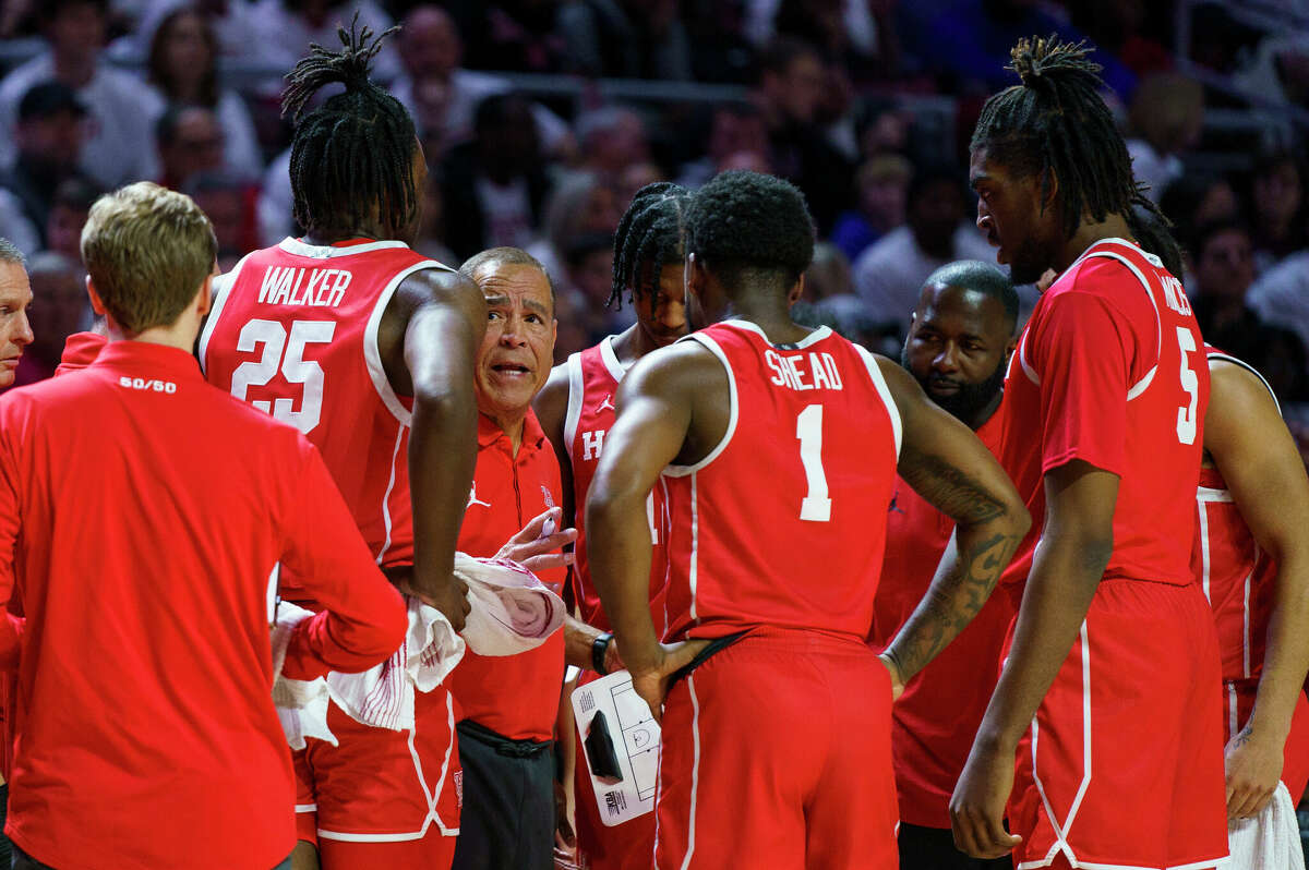 Houston head coach Kelvin Sampson, third from left, talks with his team during the first half of an NCAA college basketball game against Temple, Sunday, Feb. 5, 2023, in Philadelphia. (AP Photo/Chris Szagola)