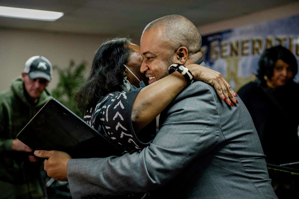 Oakland Police Chief LeRonne Armstrong hugs a supporter at his news conference where he blasted a report that he said was part of the case against him.